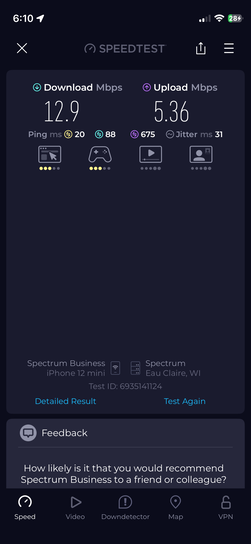 iPhone screenshot of Ookla Speedtest app showing cellular speed results on Spectrum Business network in Eau Claire, WI. Download speed is 12.9 Mbps, upload is 5.36 Mbps, with ping of 20ms and jitter of 31ms.