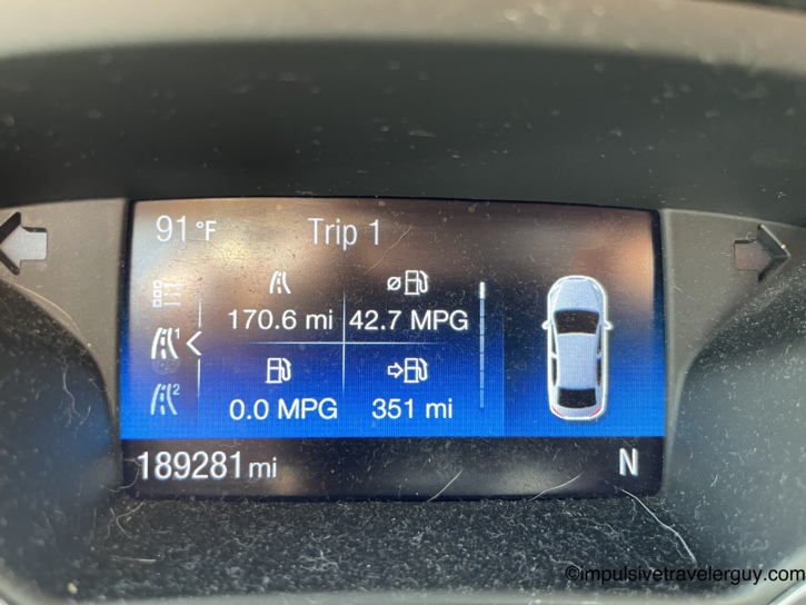 Car dashboard trip computer showing 189,281 total miles, 91 degrees outside, 170.6 miles on the trip at 42.7 MPG with 351 miles of range.