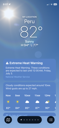 iPhone screenshot of Apple Weather app showing 82 degrees and sunny in Peru, Illinois with an Extreme Heat Warning through Friday July 3rd, high of 94 degrees.