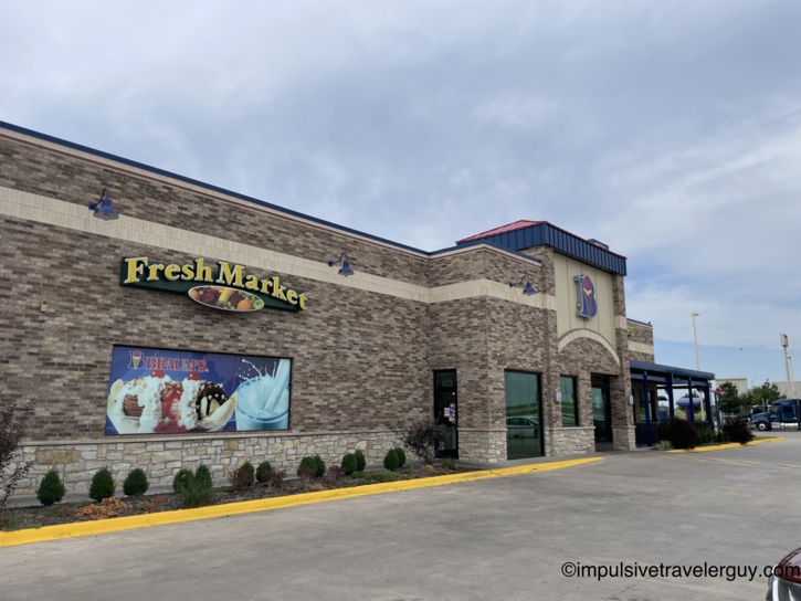Exterior view of a Braum's Fresh Market building featuring a stone and brick facade.