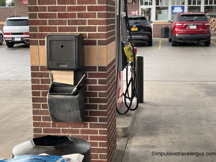 A gas station pump area at a Kwik Star with yellow out-of-order bags placed over the pump handles.