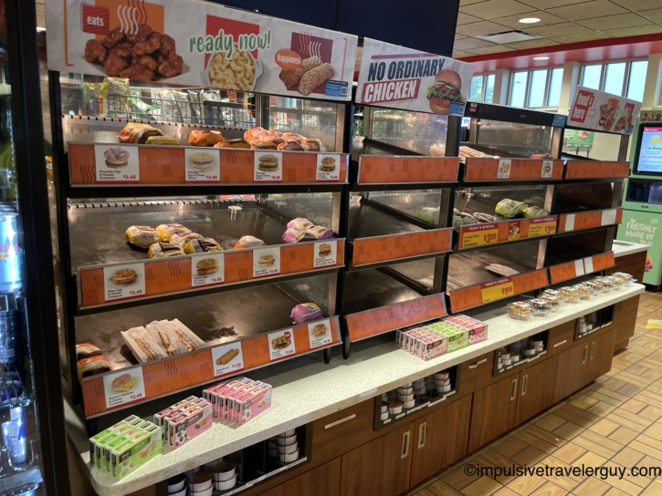 A nearly empty heated grab-and-go food display case in the Kwik Star convenience store.